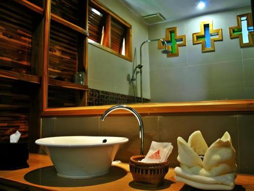 a bathroom with a sink and a mirror at Oopkaew Resort in Pua