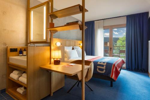 a hotel room with a bunk bed and a desk at Grand Mess Clermont-Ferrand in Clermont-Ferrand