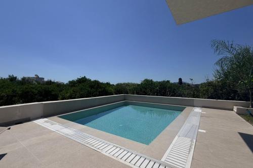 a swimming pool sitting on top of a house at Mirena Exclusive Apartments in Afantou