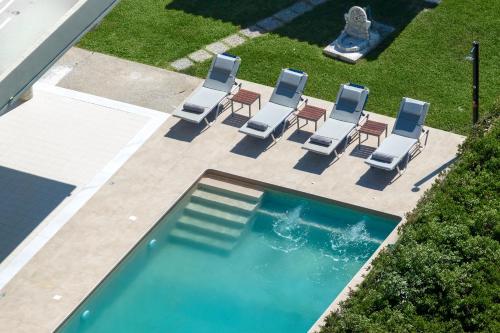 an overhead view of chairs and a swimming pool at Cielo Hillside Villa in Ialysos