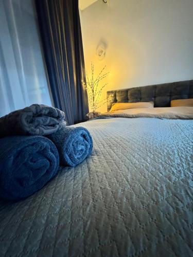 a bedroom with a bed with blue towels on it at APARTMENT Ultra central in Edineţ