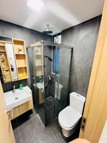 a bathroom with a shower and a toilet and a sink at The Luxe Service Suites in Kuala Lumpur