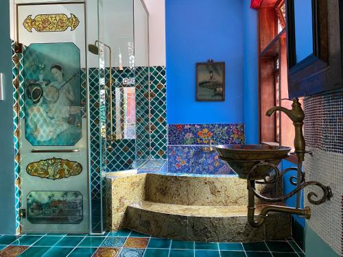 a bathroom with a sink and a blue wall at Thien Y Villas in Hue