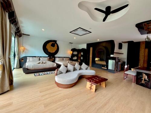 a living room with a couch and a fireplace at AC 2 Resort in Ko Tao
