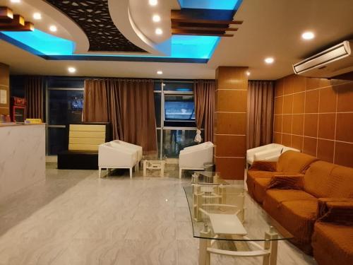 a living room with a couch and a table at Dhaka Residence Hotel in Dhaka