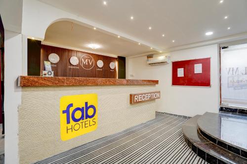 a hotel lobby with a ibid huts sign on a counter at FabHotel MV Luxury Rooms in Hyderabad