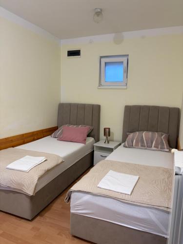 two beds sitting next to each other in a room at Studio app Ana in Kostrena