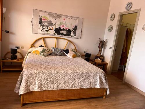 a bedroom with a bed with a wooden head board at Relax tra lago e parco in Lesa
