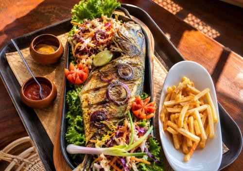 a tray of fish and french fries on a table at Giripura Resort - Kandy in Kandy