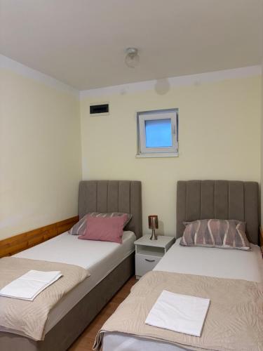two beds sitting next to each other in a room at Studio app Ana in Kostrena