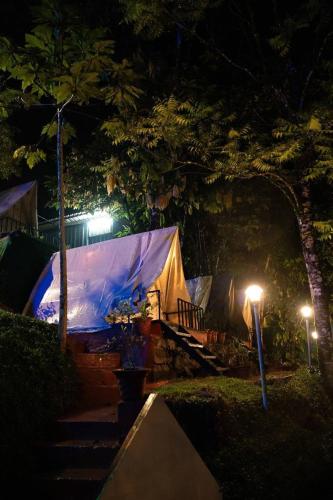 a tent in a park at night with lights at Echo Haven Glamping Tent Munnar in Munnar