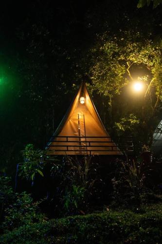 a small tent with a light on it at night at Echo Haven Glamping Tent Munnar in Munnar