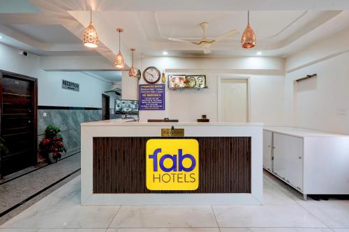 a fast food restaurant with a yellow sign on a counter at FabHotel Blue Birds in Bangalore