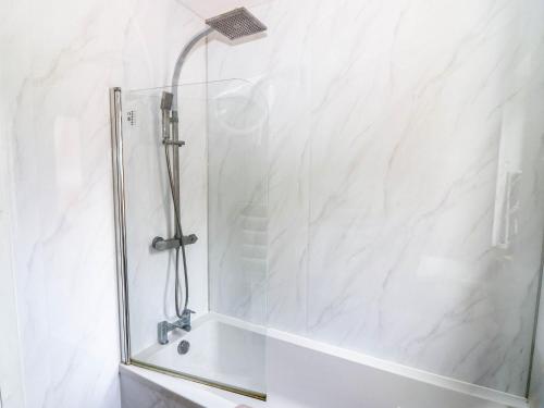 a shower with a glass door in a bathroom at 6 Niddrie Marischal Road in Edinburgh
