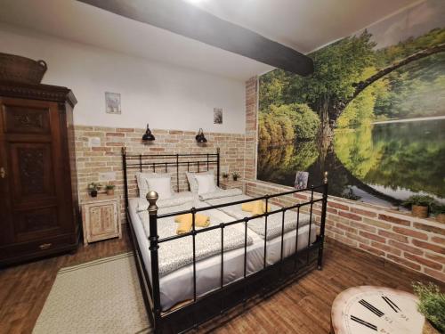 a bedroom with a bed and a brick wall at Kúria Apartman Budapest with free parking in Budapest