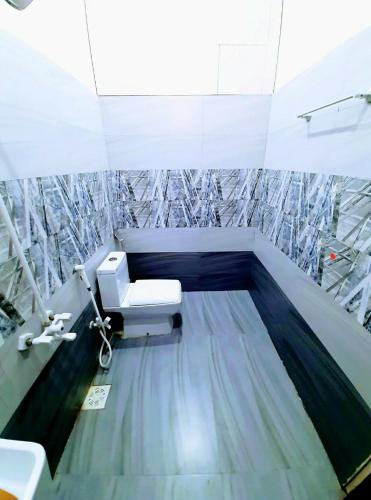 a bathroom with a sink and a toilet in a room at Galaxy Family Hotel Karachi Airport in Karachi