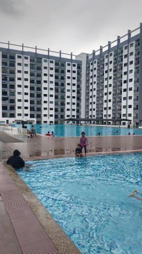 a person in a swimming pool in a large building at Afa Homestay Melaka in Malacca