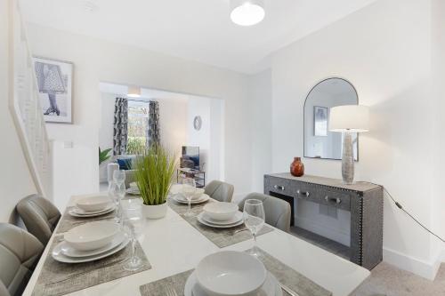 a dining room with a table and a mirror at NEW! Spacious 4BR in Sidney in Bishop Auckland