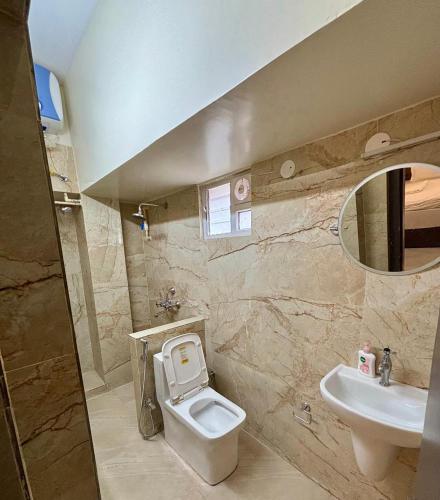 a bathroom with a toilet and a sink at Hotel Fivetel in kolkata