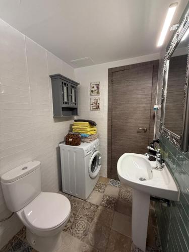 a bathroom with a toilet and a sink at Dafne's Beach in La Pineda