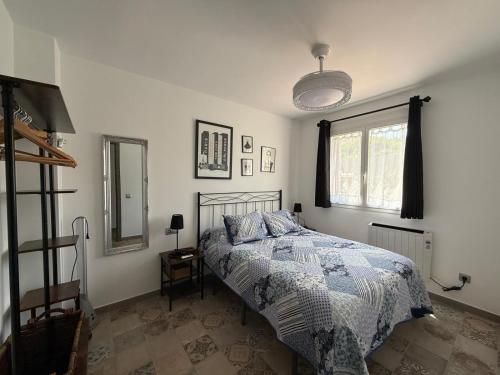 a bedroom with a bed and a window at Dafne's Beach in La Pineda
