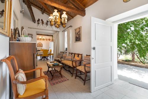 an open door into a living room with chairs at Giannis Mountain House in Aigio