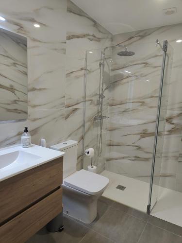 a bathroom with a shower and a toilet and a sink at Gondar Stays T2 