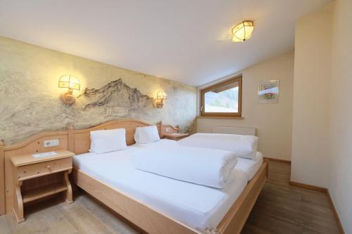 a bedroom with two beds and a wall at Banders Landhaus in Imst