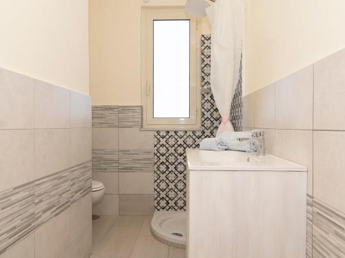 a white bathroom with a sink and a toilet at Sunset Capri by Espresso Rentals in Massa Lubrense