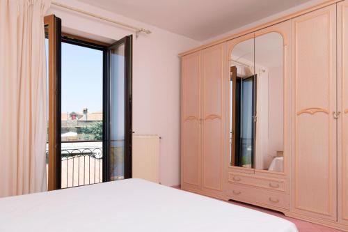 a bedroom with a bed and a large window at Sunset Capri by Espresso Rentals in Massa Lubrense