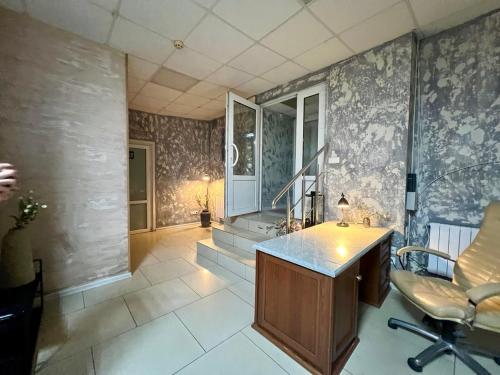 a bathroom with a sink and a desk and chairs at Podil-House-Hotel in Kyiv