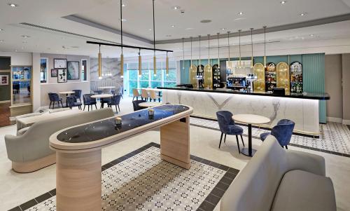 a hotel lobby with a jacuzzi tub in the middle at Hilton London Croydon in Croydon