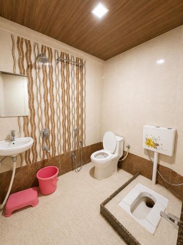 a bathroom with a toilet and a sink at Hotel Sundaram 5 Minutes Distance from Dargah in Ajmer