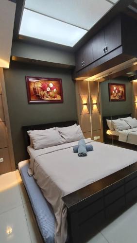 a bedroom with a large bed in a room at Grand Riviera suites Manila Condo infront of us embassy in Manila