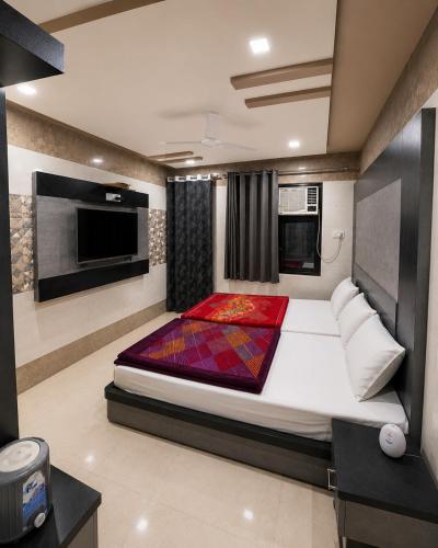 a bedroom with a large bed in a room at Hotel Sundaram 5 Minutes Distance from Dargah in Ajmer