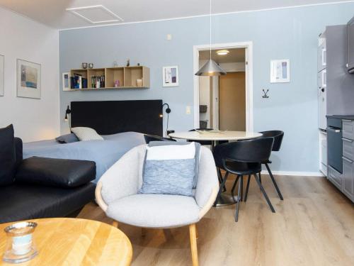 a bedroom with a bed and a couch and a table at 2 person holiday home in Hejls in Hejls
