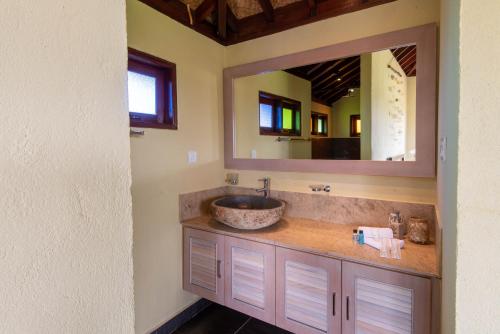 a bathroom with a sink and a mirror at Cathaya Private Pool Villa - Limasan Padi in Langkawi Intl