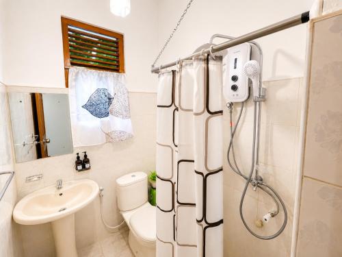 a bathroom with a shower and a toilet and a sink at PearlDrop Hills Kandy in Kandy