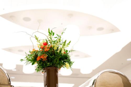 a vase filled with flowers on top of a table at I Hotel and Illinois Conference Center - Champaign in Champaign