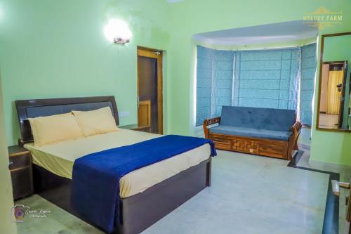 a bedroom with a bed and a bench in it at The Mint Resort in Gurgaon