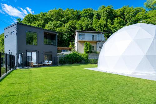 a large white tent in front of a house at Awaji Play Resort in Minamiawaji