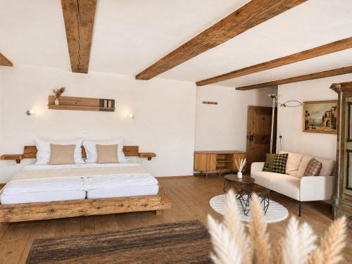 a bedroom with a bed and a couch at s'Morent in Zöblen