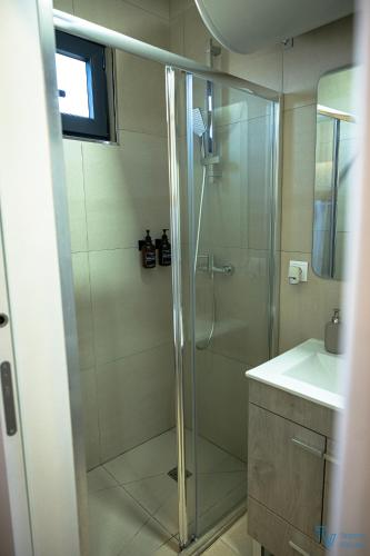 a bathroom with a shower and a sink at Trendy Villas Hostel in Vila Chã