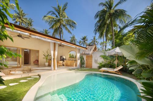 a swimming pool in the backyard of a villa at Gili Boho Villas - Aesthetic Private Pool Villas in Gili Trawangan