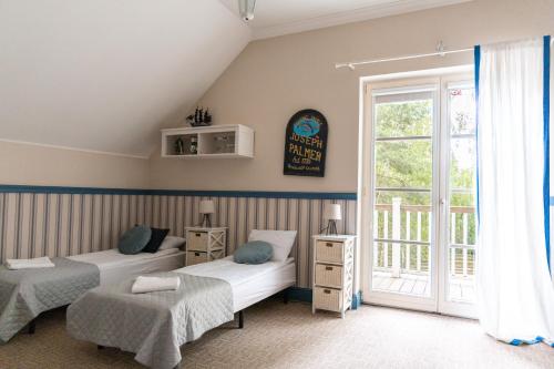 a bedroom with two beds and a window at Dwór Złotopolska Dolina Modlin Airport in Trębki