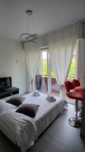 a bedroom with a large white bed and red chairs at MilanoValery3 in Milan