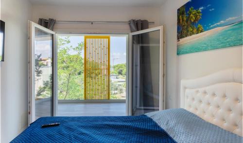 a bedroom with a bed and a sliding glass door at Don Cesar Palace in Bibione