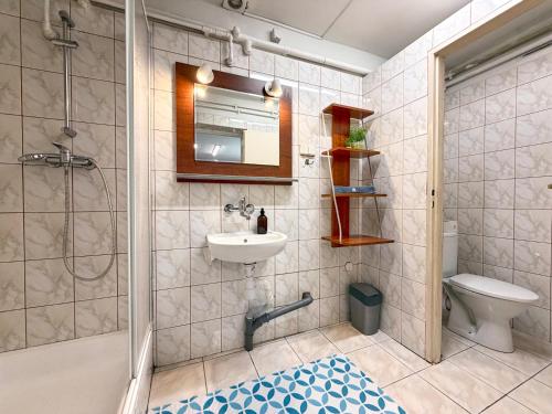 a bathroom with a shower and a sink and a toilet at Hostel Relax in Warsaw