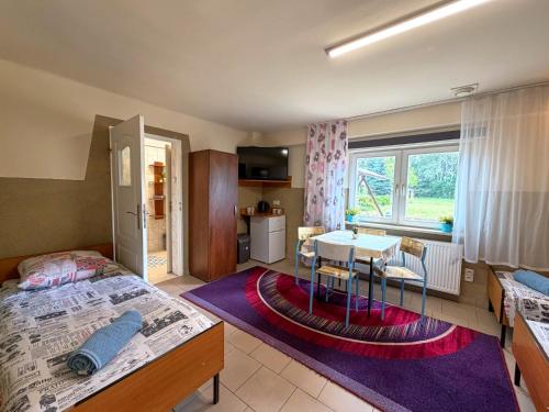 a bedroom with a bed and a table in it at Hostel Relax in Warsaw