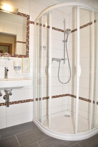 a bathroom with a shower and a sink at Hotel Gasthof Kamml in Wals